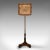 This is an antique adjustable pole screen. An English, rosewood and needlepoint fireside shield, dating to the Regency...
