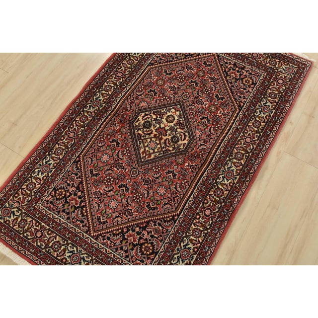 An authentic vintage traditional Bidjar rug hand-knotted with fine wool and natural dyes. This intricately woven rug...
