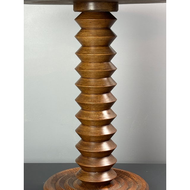 Stunning French side table from the 1940s- 1950s constructed in medium dark oak. The bases are generally made of...