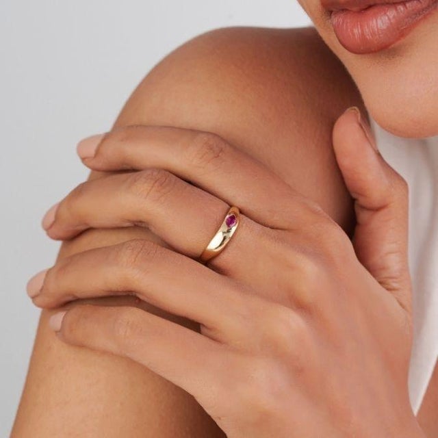 This elegant signet ring features a 0.2 ct marquise-cut natural ruby, set in 14K yellow gold. The ruby measures 5 × 2.5 mm...
