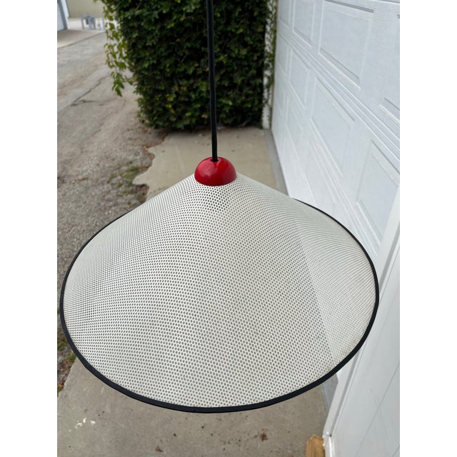 Wonderful and sculptural postmodern pendant light with a striking perforated conical shade, designed in the Memphis or...