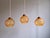 Trio of Art Deco pendant lights/portal lamps in amber cracked glass, 1920s-30s. Each of the pendant lights has been re-...