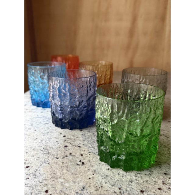 Six multicoloured rocks glasses in the 'Bark' texture in the style of Geoffrey Baxter (Whitefriars). Italy - Circa 1960's....