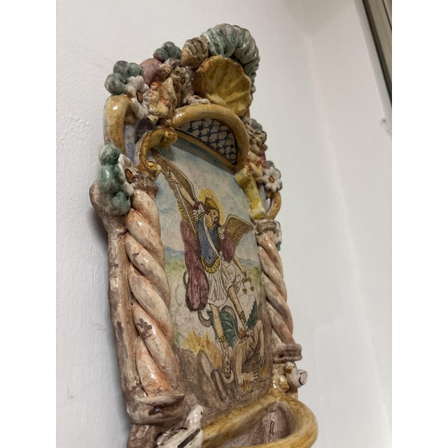 The giant holy water stoup of St. Michael the Archangel is the warrior angel par excellence. His name derives from the...