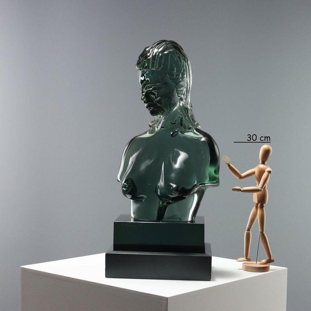 Glass sculpture depicting the bust of a young woman. The author's signature and production date are engraved on the base....