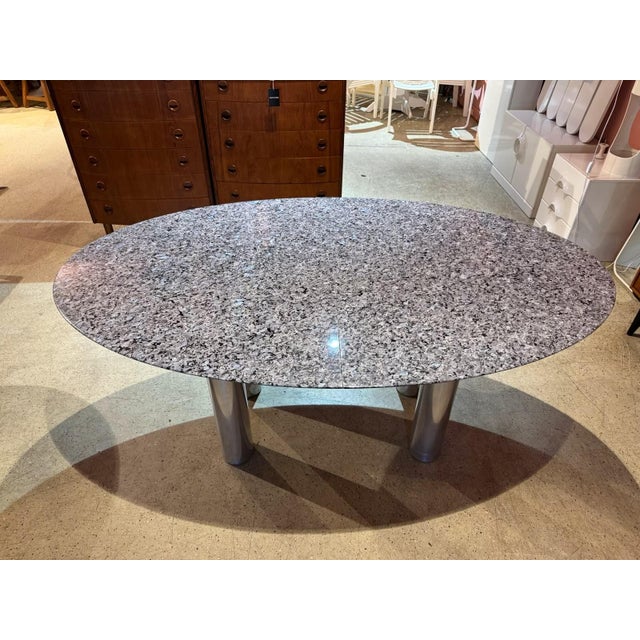 A stunning, extendable granite dining table by Draenert. The granite is most likely Labrador Silver. Depending on the...