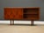 A mid century modern teak credenza with two sliding doors, two shelves and tapered legs. Professionally refinished....