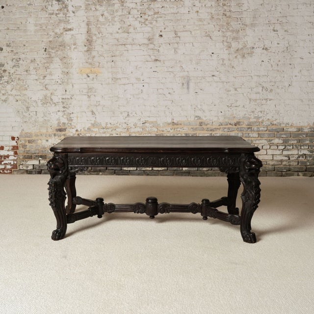 A 19th-century French wooden table featuring a richly patinated plank top with natural wear that highlights its age and...