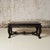 A 19th-century French wooden table featuring a richly patinated plank top with natural wear that highlights its age and...