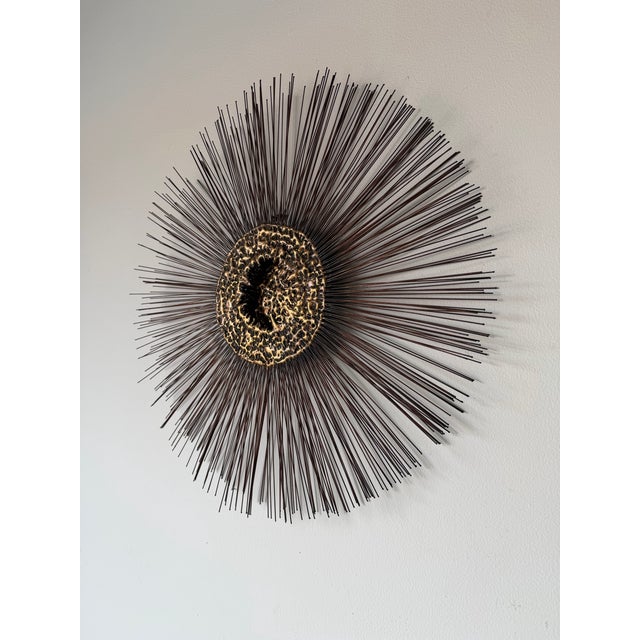 Striking 1970s Mid-Century Modern Brutalist starburst wall sculpture in the manner of Curtis Jere. This dramatic wall-...