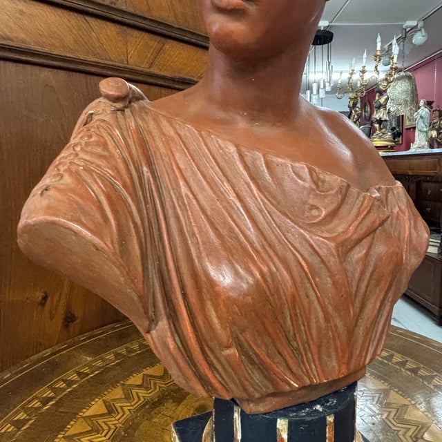 Splendid antique terracotta sculpture with a 19th-century patina and a painted wooden base. Excellent. Dimensions: H 52...