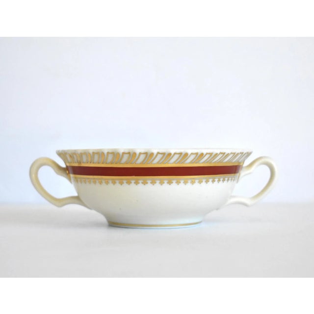A vintage 1934-1948 Lenox china cream soup bowl with handles, in the deep red burgundy and gold gilt "Georgian" pattern....