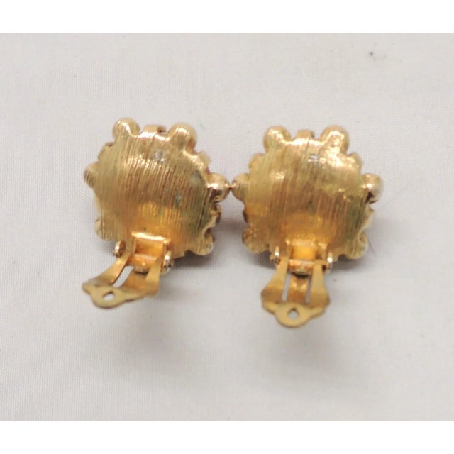 This is part of Chairish’s Costume Jewelry assortment. 1950s goldtone cabochon faux-carnelian centers with small round...