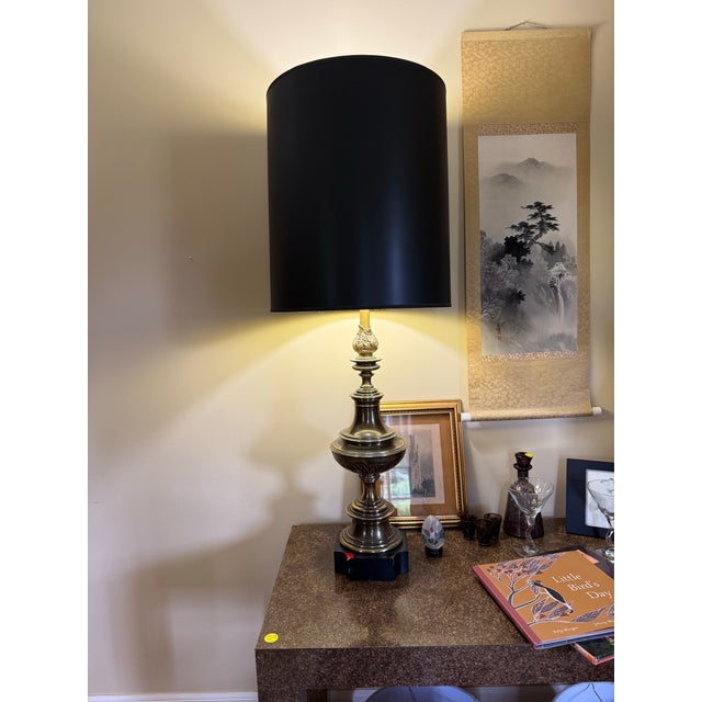 An exceptional curated pair of monumental vintage Stiffel solid brass table lamps, beautifully composed in complementary...
