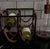 Arthur Umanoff wine rack with blackened iron framework and saddle leather supports, embodying the understated...
