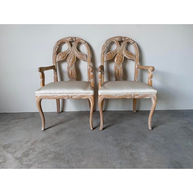 Elegant pair of vintage Regency style dining chairs featuring beautifully sculpted faux bois frames with stylized palm and...