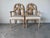 Elegant pair of vintage Regency style dining chairs featuring beautifully sculpted faux bois frames with stylized palm and...
