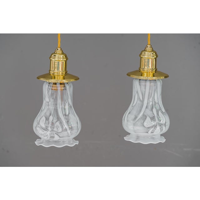 2 Art Deco pendants vienna around 1920s with opaline glass shades. Brass polished and stove enameled. Original old opaline...