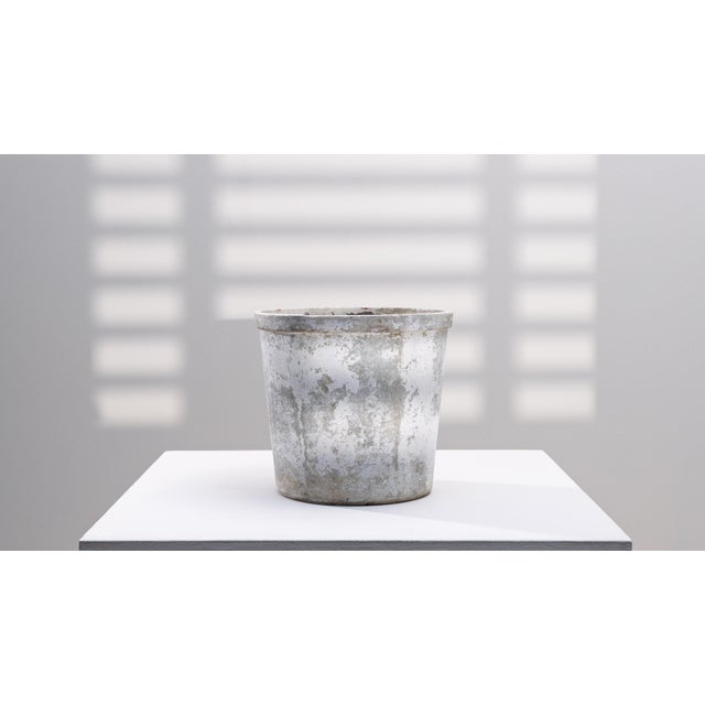 1960s French Concrete Planter. This mid-century French concrete planter offers a clean, utilitarian form softened by...