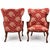This is a pair of antique French carved mahogany wing chairs in a vintage Schumacher red and white fabric. They have brass...
