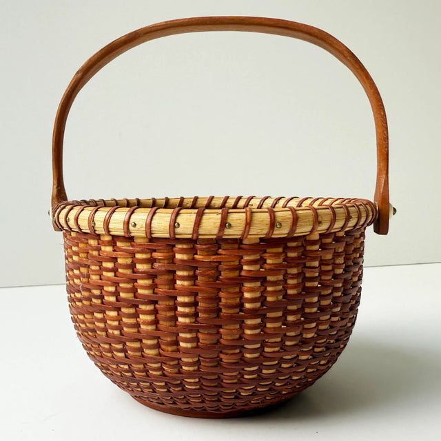 This beautifully handcrafted vintage Nantucket Lightship Basket is a signed piece, marked by the artisan on the underside....