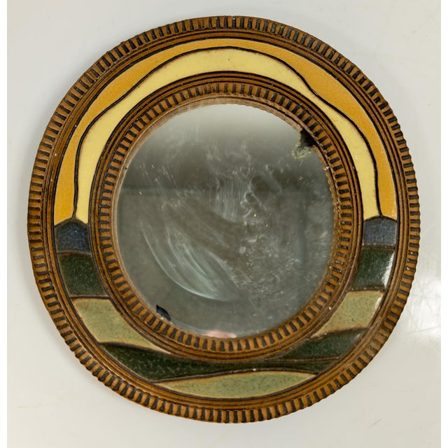 We are selling this decorative late 20th century contemporary art pottery mirror. This round mirror has cool style and...