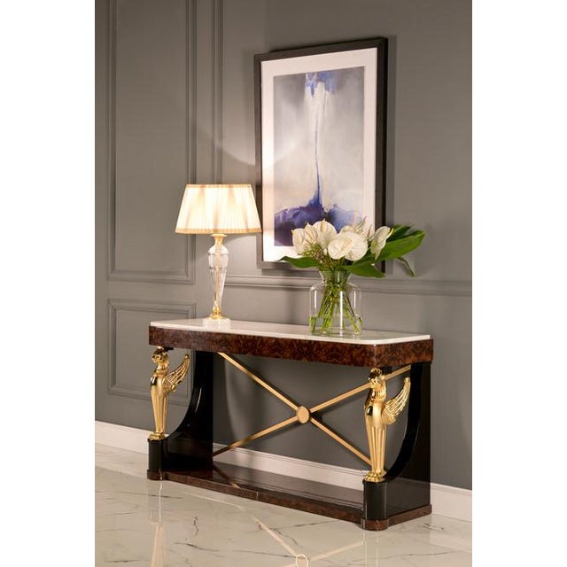 A commanding presence of Empire-era refinement, this handcrafted console table is a striking blend of luxurious materials...