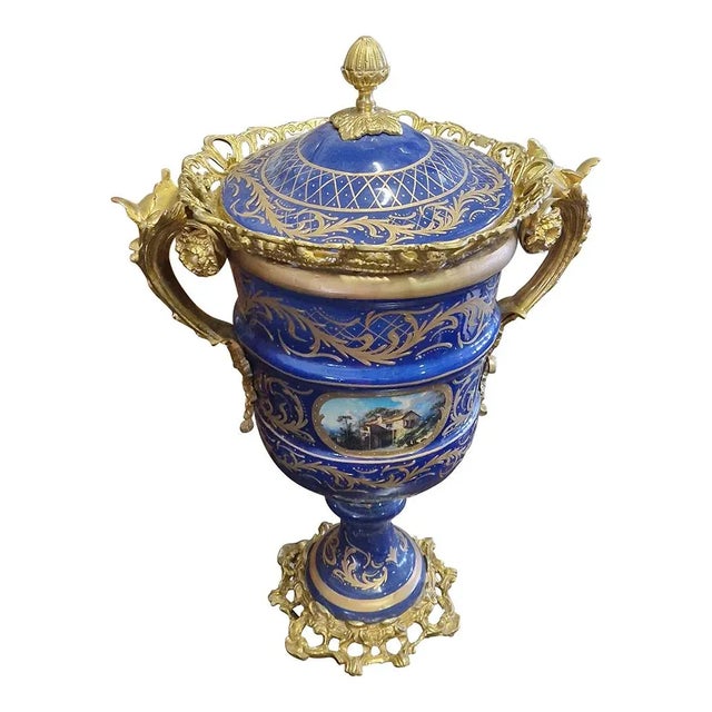 Pair of French style vases, in blue/gold porcelain with gilded bronze elements and base. Dimensions (LxH) 53 x 75 cm