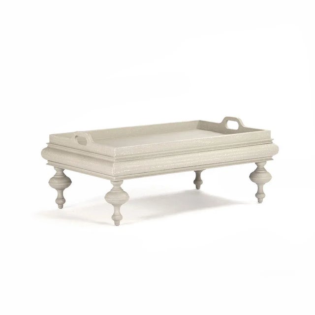 Coffee table with serving tray like top in distressed ivory finish.