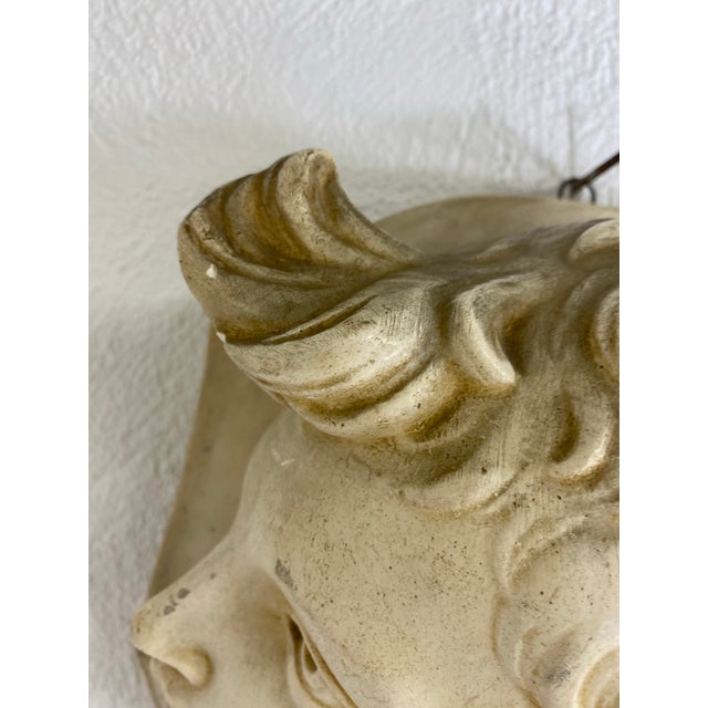 This is a mid-century vintage plaster freeze of a young male angel. This hanging wall sculpture is a three-dimensional...