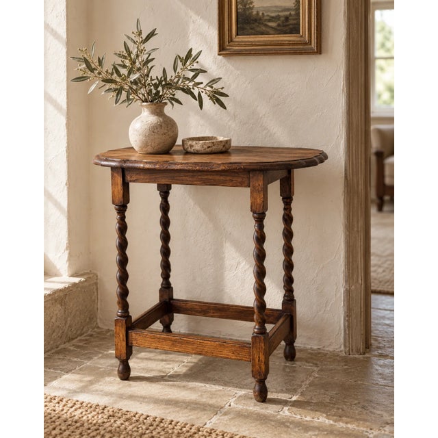 A small table with very good manners. This antique English occasional table dates to the early 20th century and combines a...