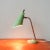 This Mid-century table lamp was designed and produced in Italy, during the 1950s. It has a light green base where a brass...