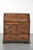 This beautiful antique English oak secretary desk from the early 18th century features a graceful and elegantly curved...