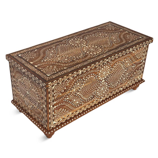 Handcrafted in India from solid teak wood, this vintage inlay storage trunk is a striking blend of artistry and...