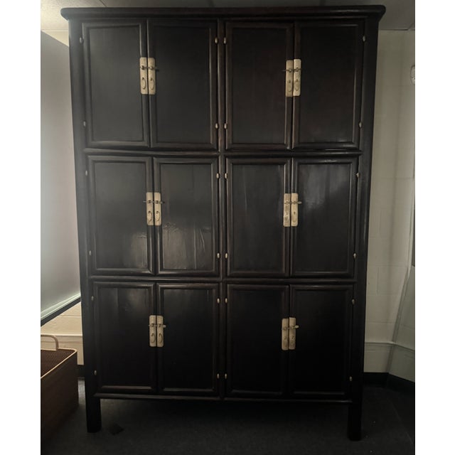 Statement Storage Piece. Handsome reproduction Chinese apothecary style cabinet with ebony stained finish and brass...