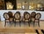 A set of 8 Barbara Barry classic "Oval X" dining chairs. Each frame is made of beech hardwood and stained mahogany with...