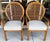 Pair of sculptural rattan peacock chairs from 1970s, featuring a distinctive scroll arm and balloon back design. Hand-...