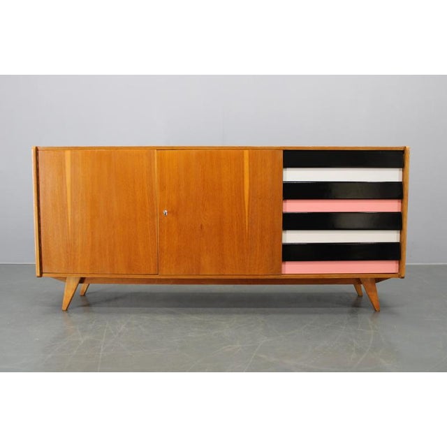 This refined mid-century sideboard was designed by Jiří Jiroutek in Czechoslovakia during the 1960s and represents a key...