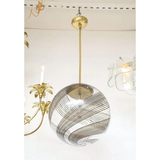 1960's Mid-Century Modern Venini glass and brass pendant, in vintage condition with minor wear and patina due to age and...