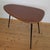 This mid-century side table was designed in the 1950s and is in very good condition, with a flawless mahogany top. All...