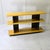 This low, open console table is an emblematic example of the rational functionalism and modular aesthetic developed by...