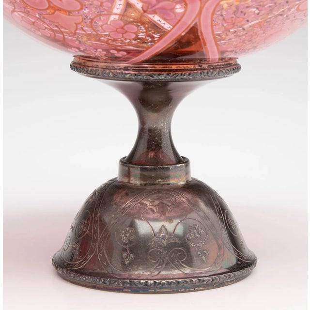 Late 19th-century Moser Bohemian art glass compote in richly colored cranberry glass, hand decorated with polychrome...