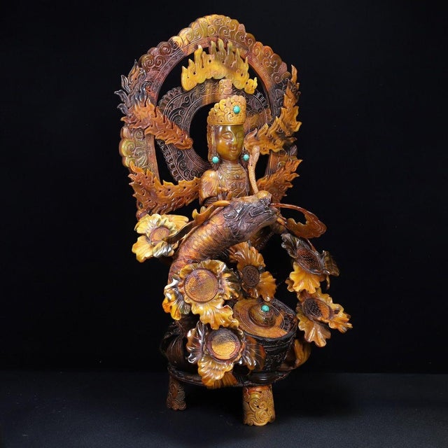 This is a monumental and highly intricate sculpture, masterfully carved to resemble translucent amber or aged horn. The...