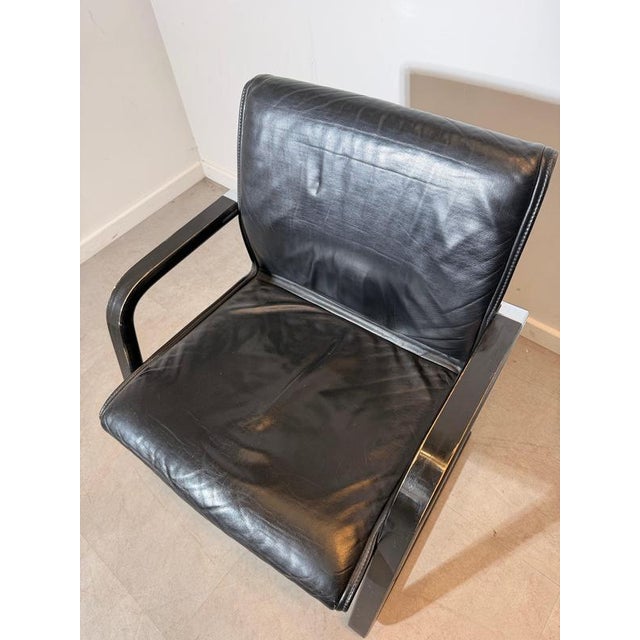Striking vintage armchair by Wilkhahn , featuring a sculptural cantilever frame combined with beautifully aged black...
