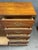 Vintage Bassett chifforobe featuring a warm wood finish, decorative Chinoiserie floral and landscape motifs, and brass-...