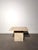 Elegant vintage travertine side table featuring a solid architectural pedestal base and a thick square top with softly...