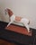Hand carved folk art horse sculpture in painted wood, featuring an elongated silhouette with carved mane and saddle...
