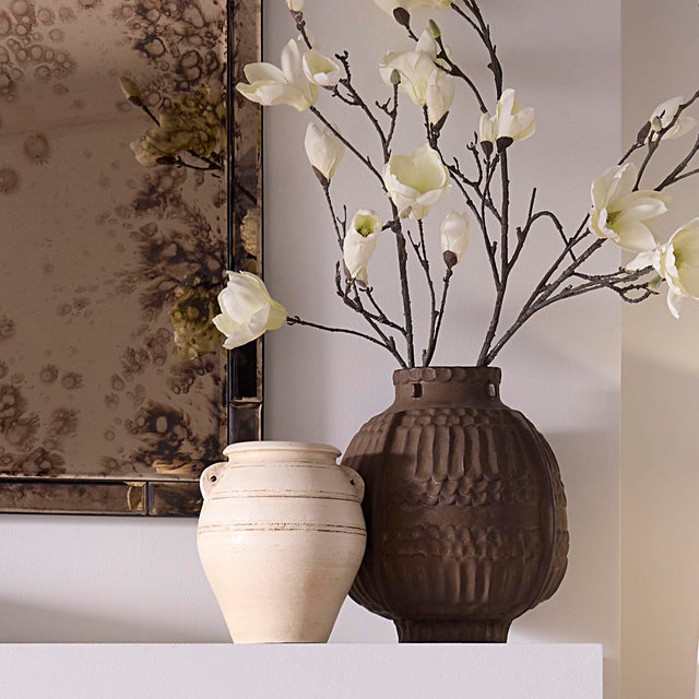 Delicate and soulful, this handcrafted ceramic vase is pure poetry in form and texture. The artists hand is evident in...