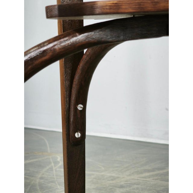 An elegant early 20th-century Thonet Model No. 207 oval bentwood table, produced circa 1910s by Mazowia in Poland under...