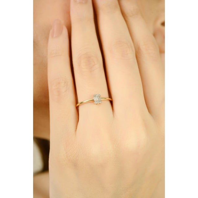 This elegant ring features a cluster of baguette and round-cut diamonds totaling 0.11 carats, set in a sleek 14K yellow...